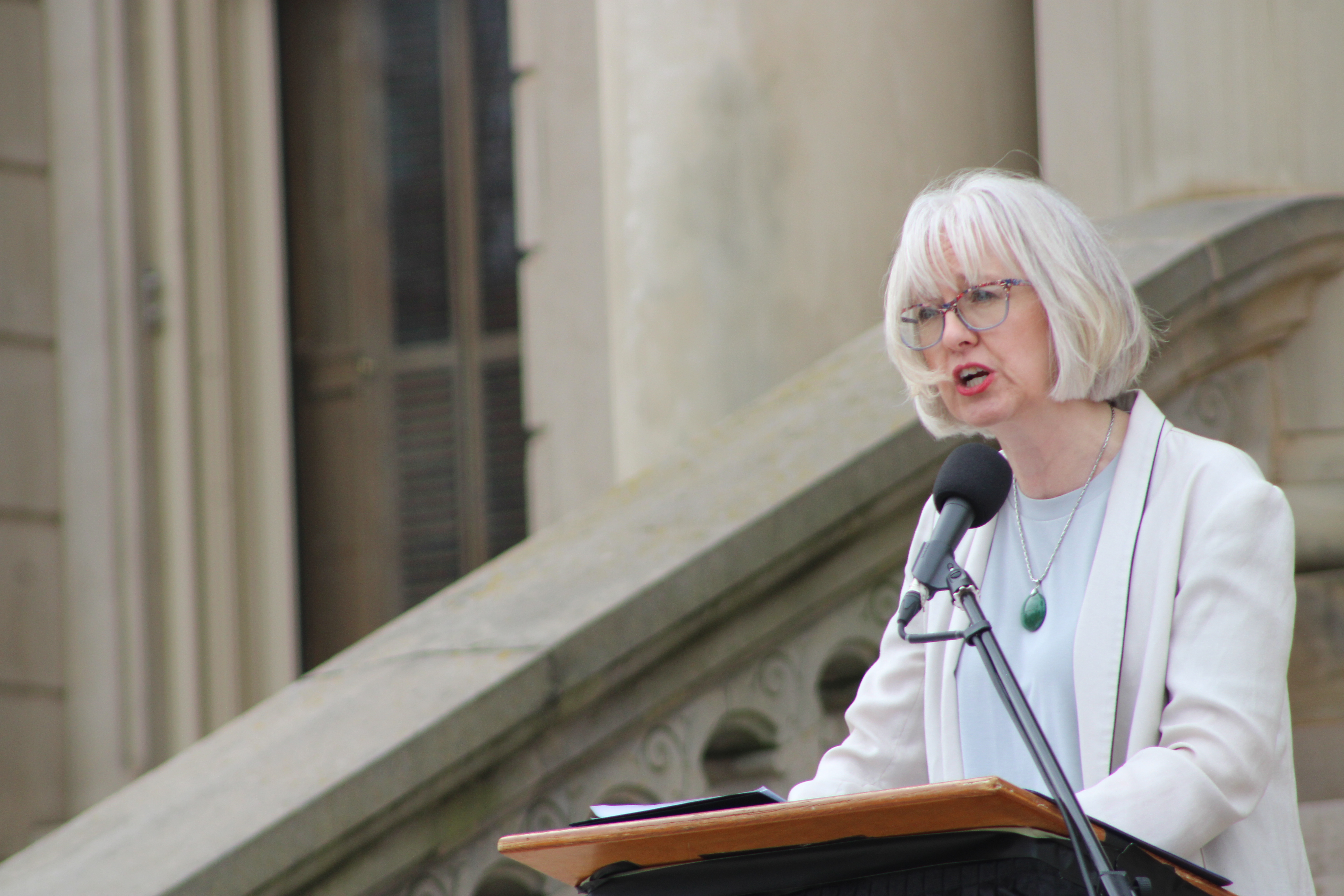 Dr. Stephanie Nawyn speaking on the steps of the Michigan Capitol